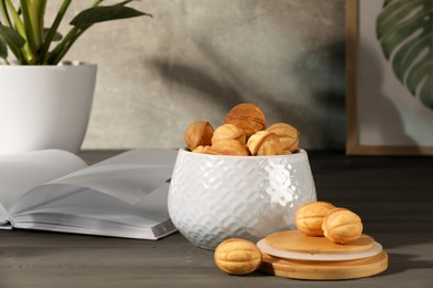 Freshly baked walnut shaped cookies on grey wooden table. Homemade pastry filled with caramelized condensed milk