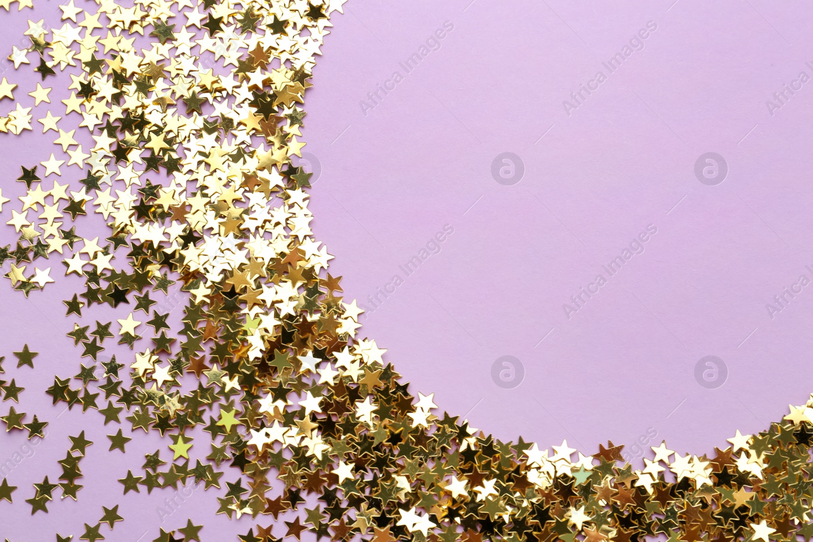 Photo of Confetti stars on violet background, flat lay with space for text. Christmas celebration