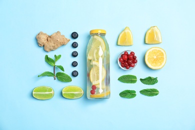 Photo of Flat lay composition with delicious natural lemonade on color background