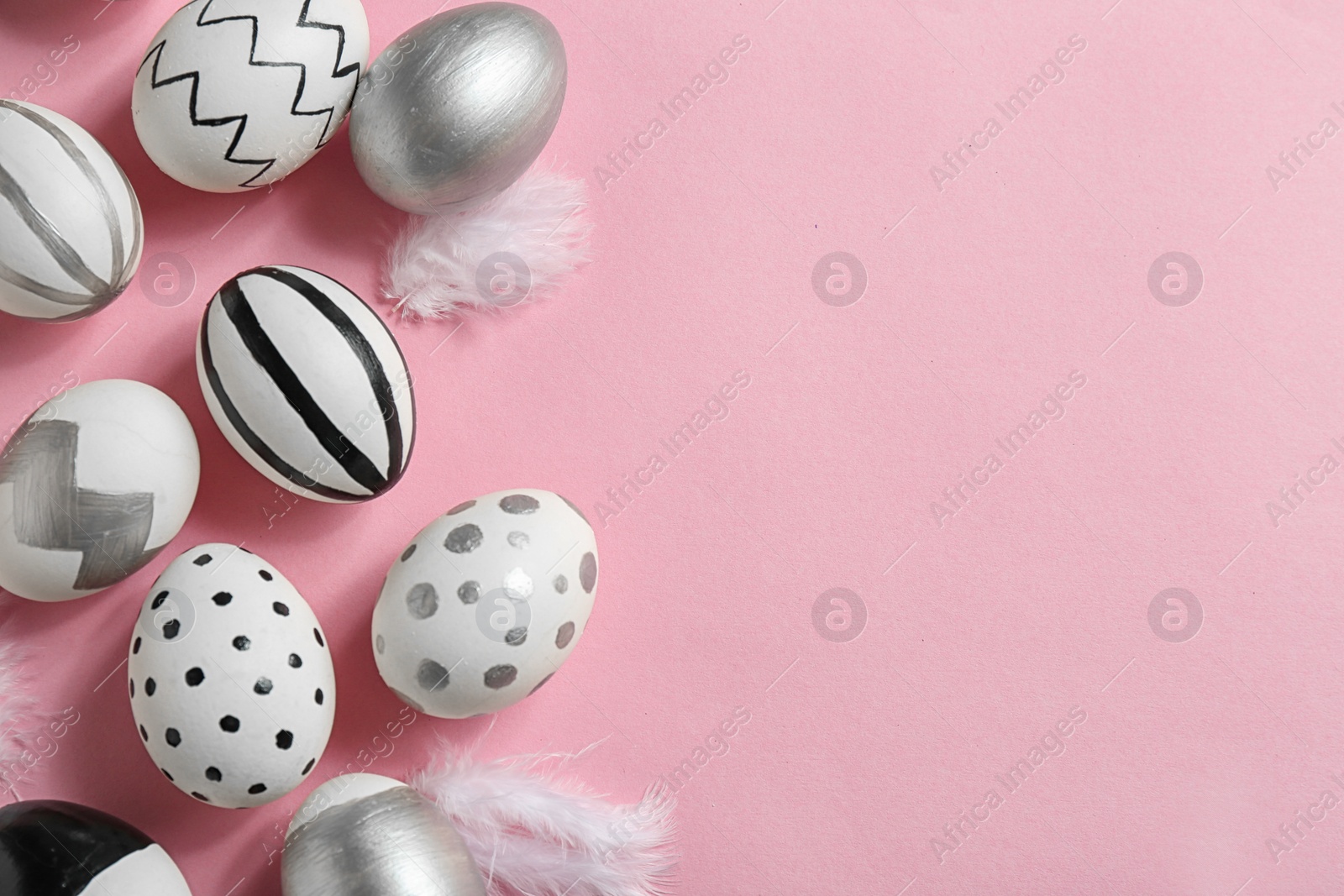 Photo of Painted Easter eggs on color background, flat lay with space for text