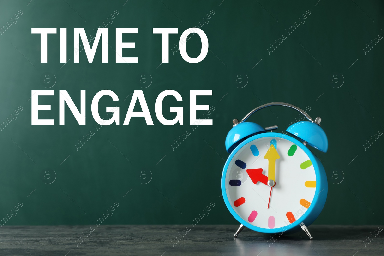 Image of Text Time to engage on green chalkboard near alarm clock