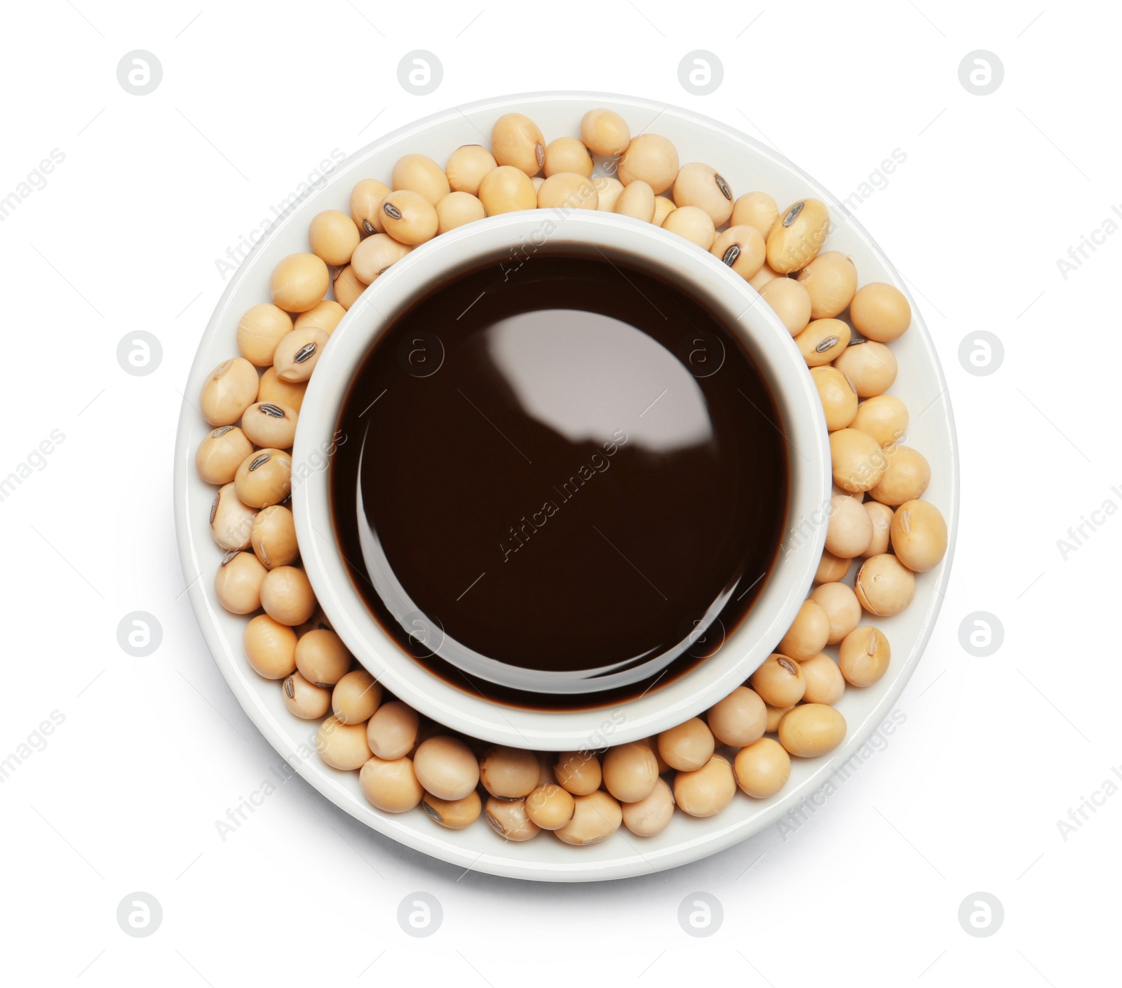 Photo of Dish of soy sauce with beans on white background, top view