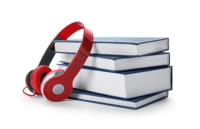 Photo of Modern headphones with hardcover books on white background