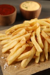 Delicious french fries on table, closeup view