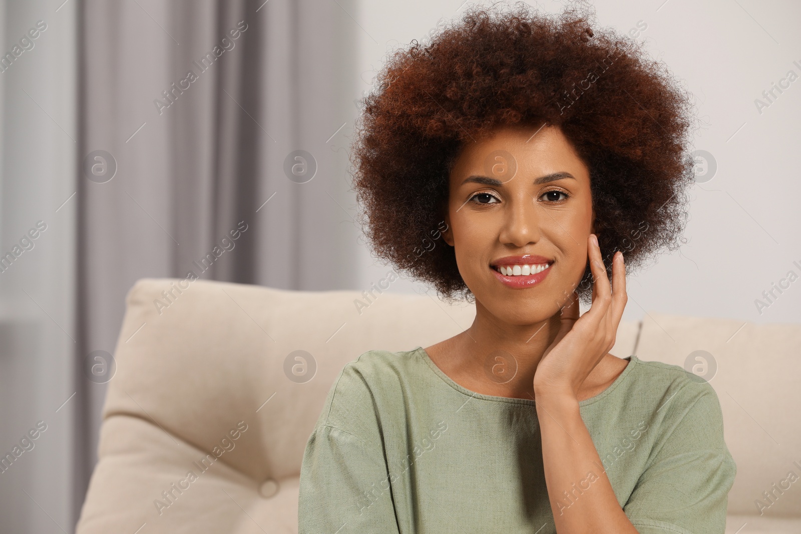 Photo of Portrait of beautiful young woman with glamorous makeup at home. Space for text