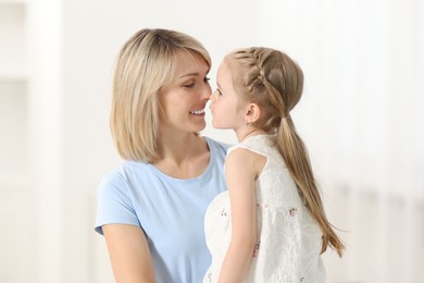 Happy mother and her daughter at home