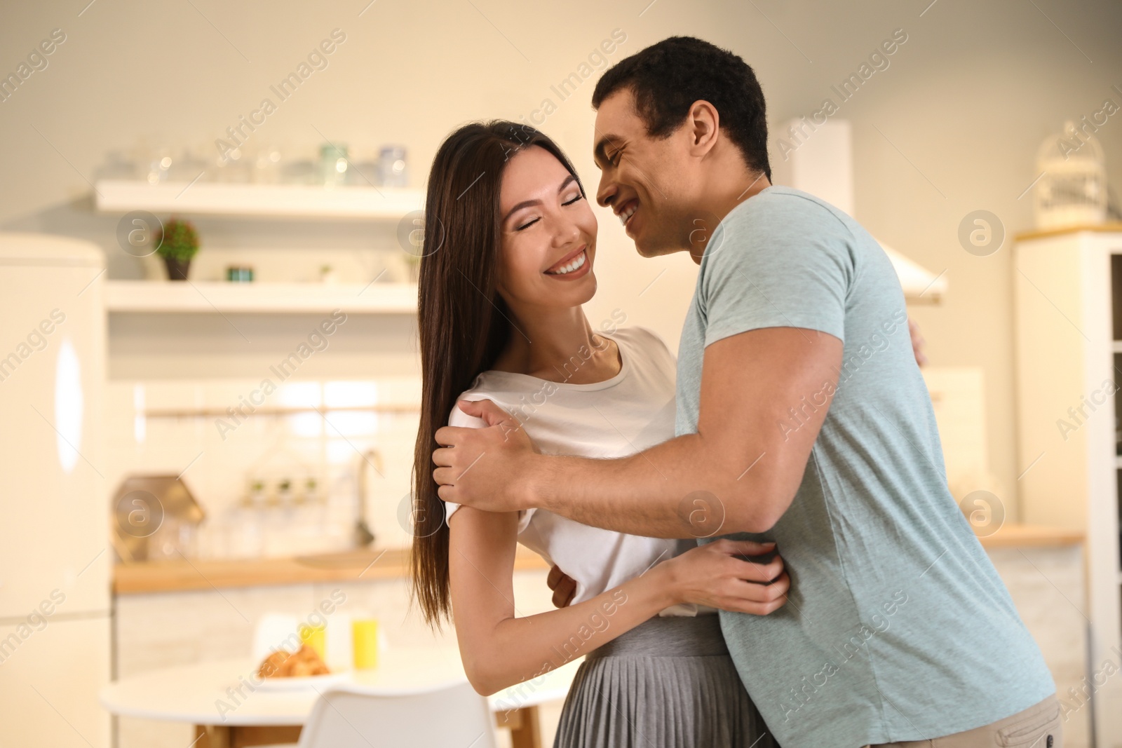 Photo of Lovely young interracial couple dancing at home