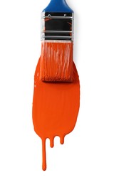 Photo of Brush with orange paint on white background