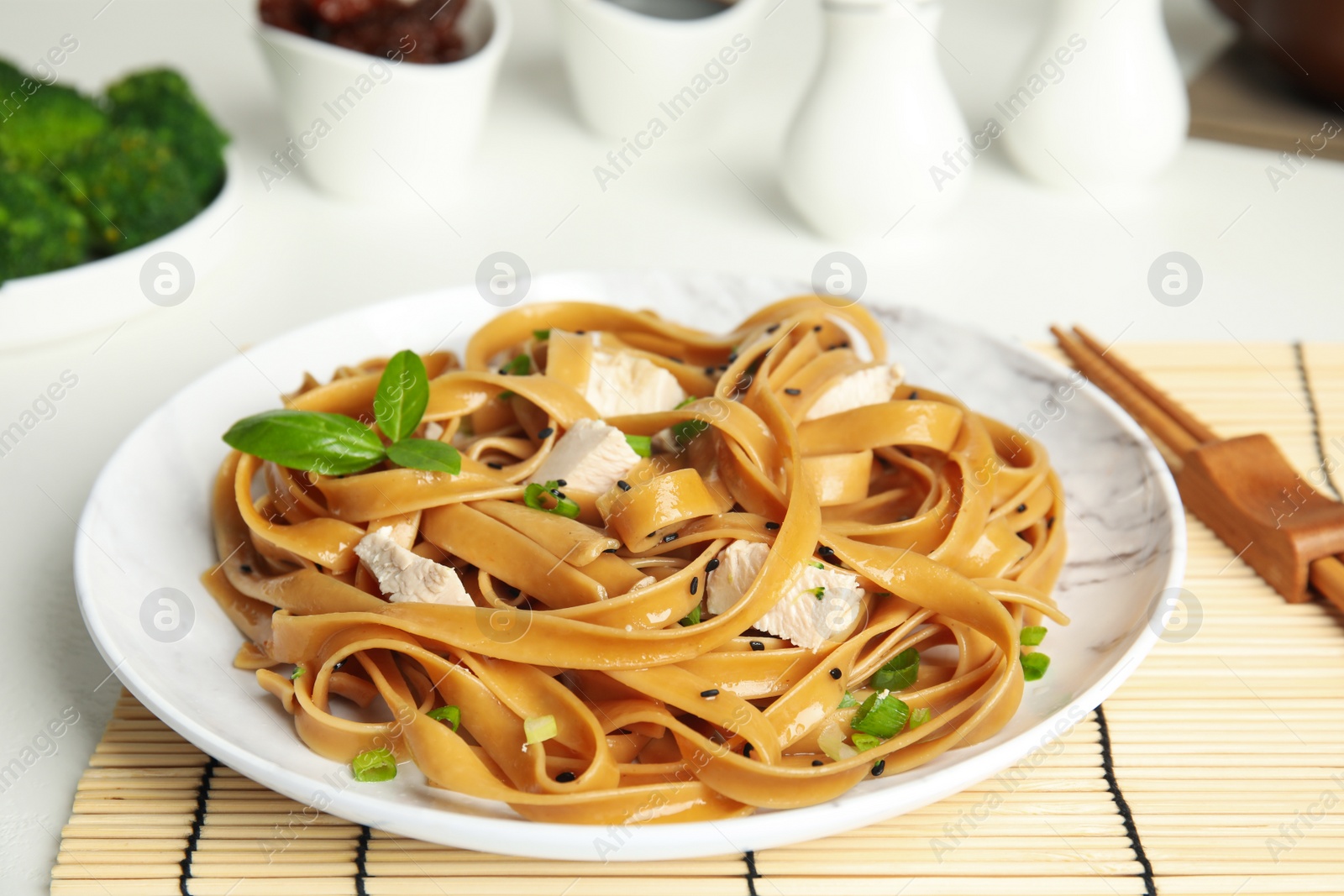 Photo of Tasty buckwheat noodles with meat served on table