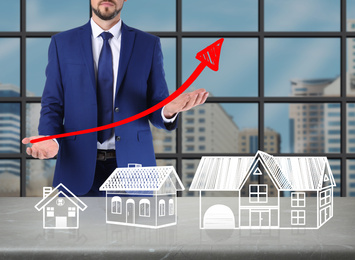 Real estate agent demonstrating prices at housing market. Man with graph illustration, closeup