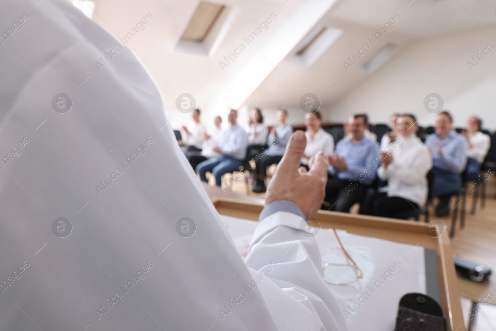 Photo of Doctor giving lecture during medical conference in meeting room, closeup