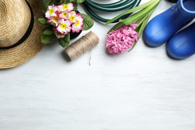 Photo of Flat lay composition with gardening equipment and space for text on wooden background