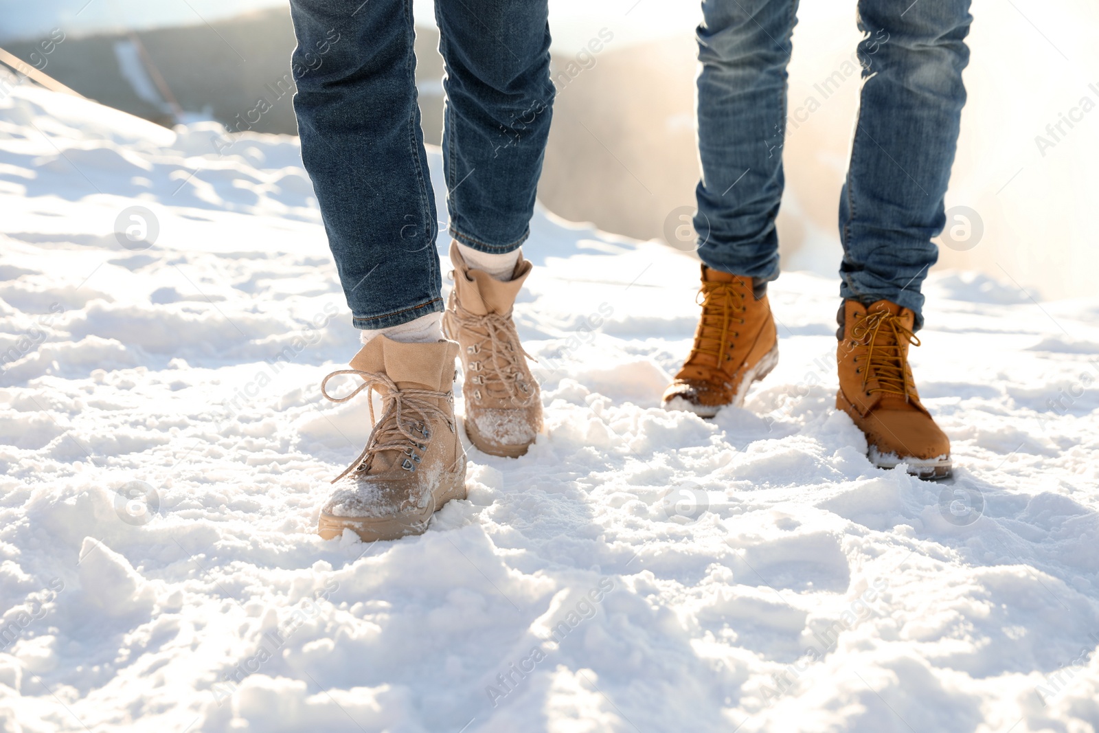 Photo of Couple walking on sunny winter day after snow storm