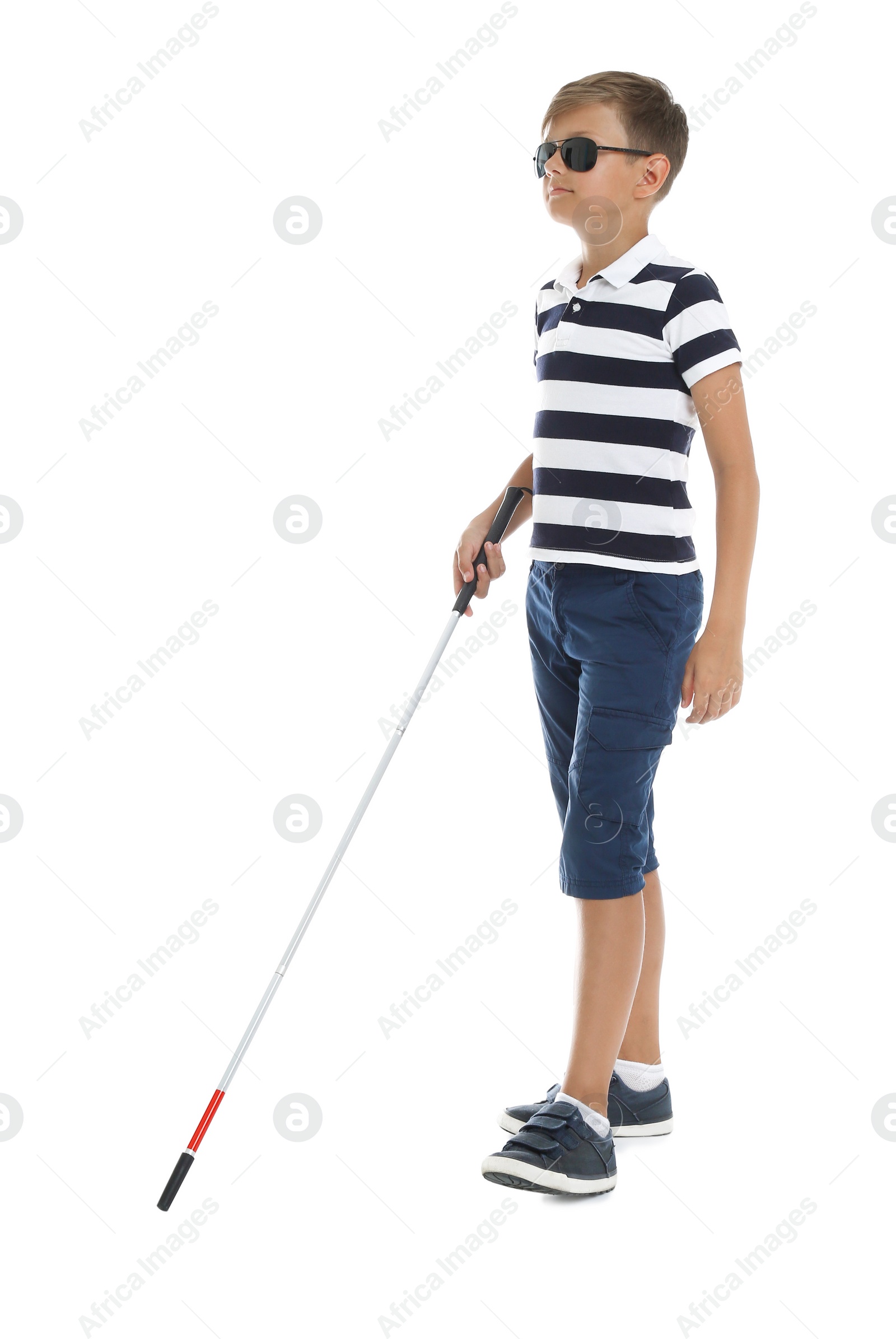 Photo of Blind boy with long cane walking on white background