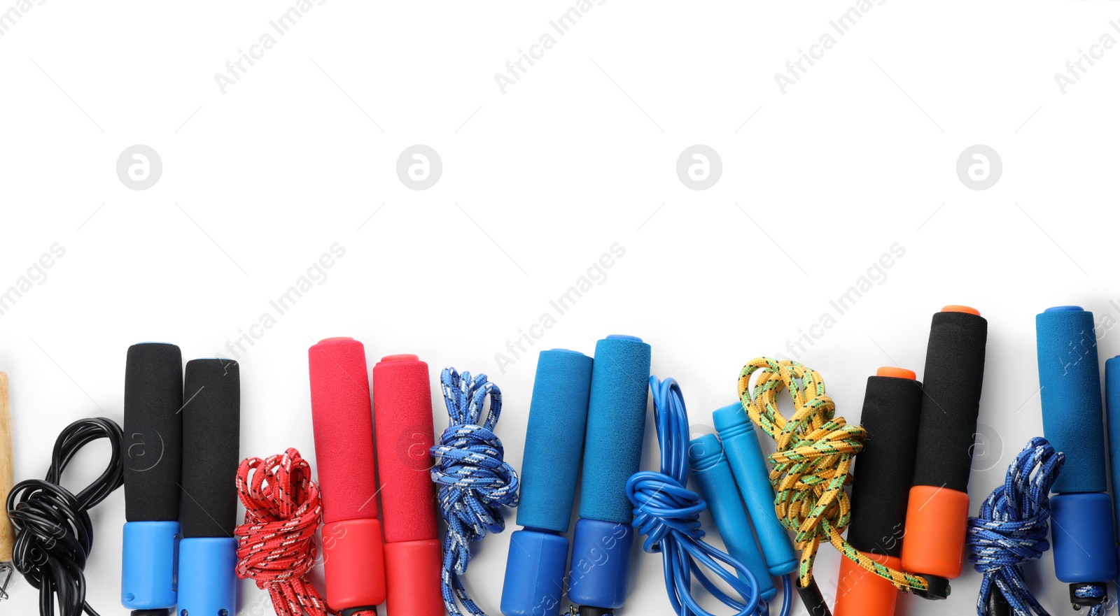 Photo of Set of jump ropes on white background, top view with space for text