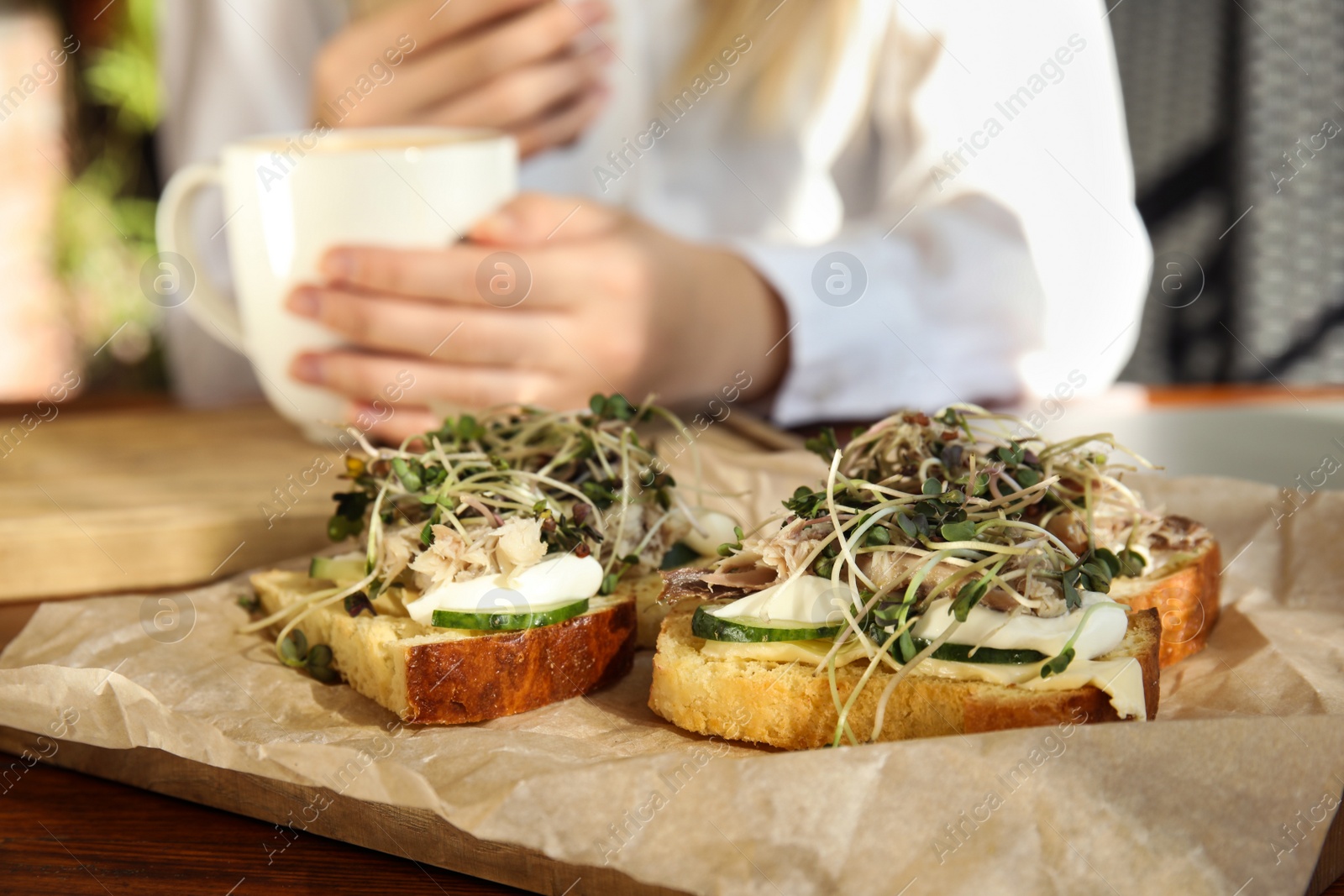 Photo of Food blogger in cafe, focus on delicious bruschettas