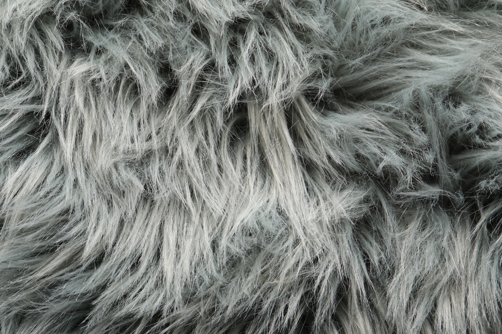 Photo of Texture of grey faux fur as background, top view