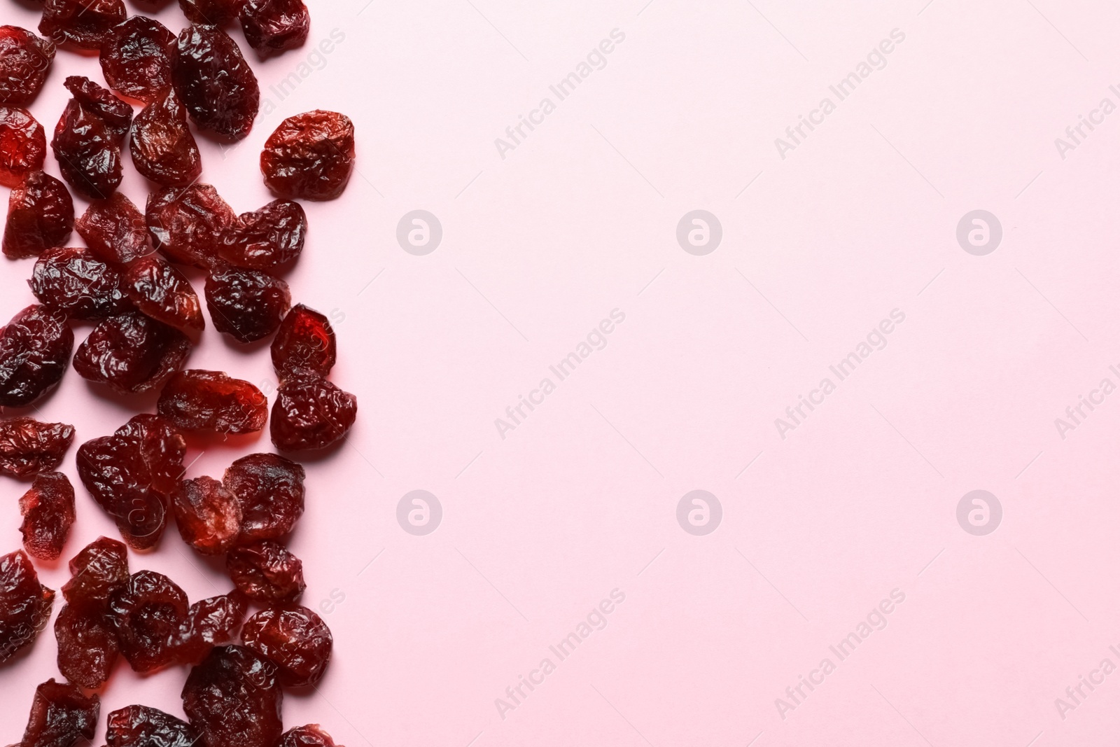 Photo of Cranberries on color background, top view with space for text. Dried fruit as healthy snack