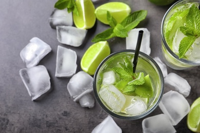 Refreshing beverage with lime and mint on table
