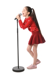 Photo of Little girl singing into microphone on white background