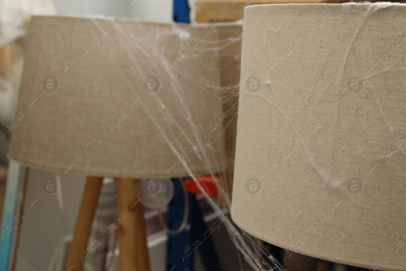 Photo of Old cobweb on lamps in room, closeup