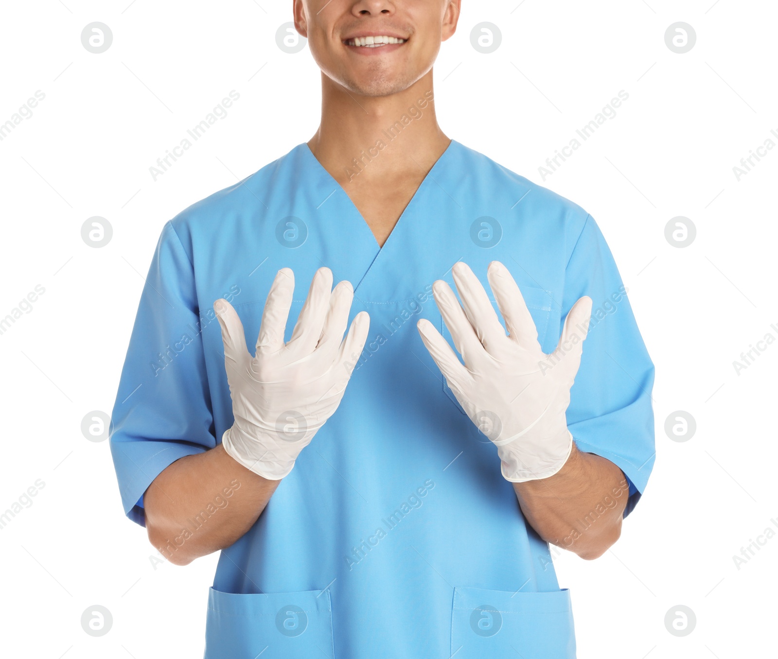 Photo of Male doctor in uniform wearing gloves on white background, closeup. Medical object