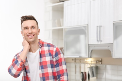 Photo of Portrait of handsome young man in kitchen