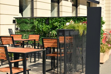 Photo of Outdoor cafe with beautiful plants and comfortable furniture