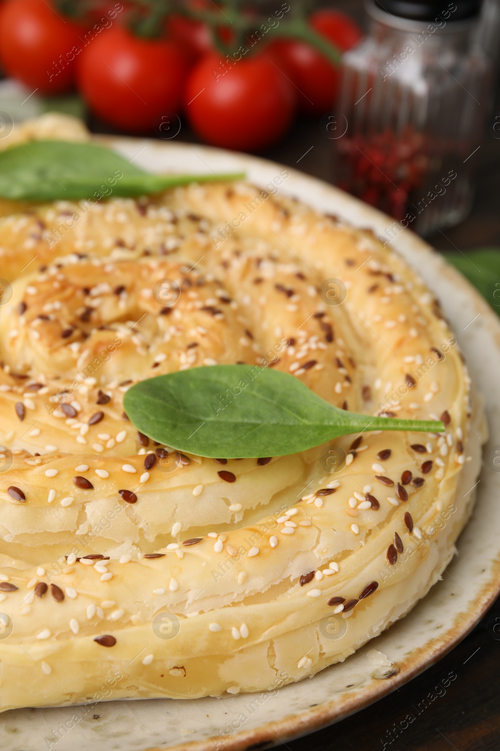 Photo of Delicious puff pastry with spinach on table, closeup