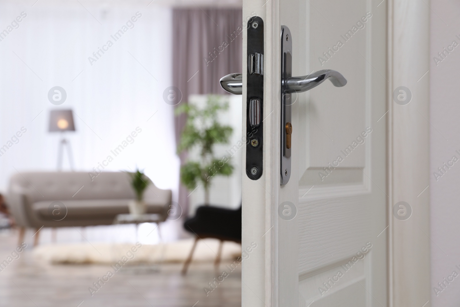 Photo of Closeup of open door in modern apartment, space for text