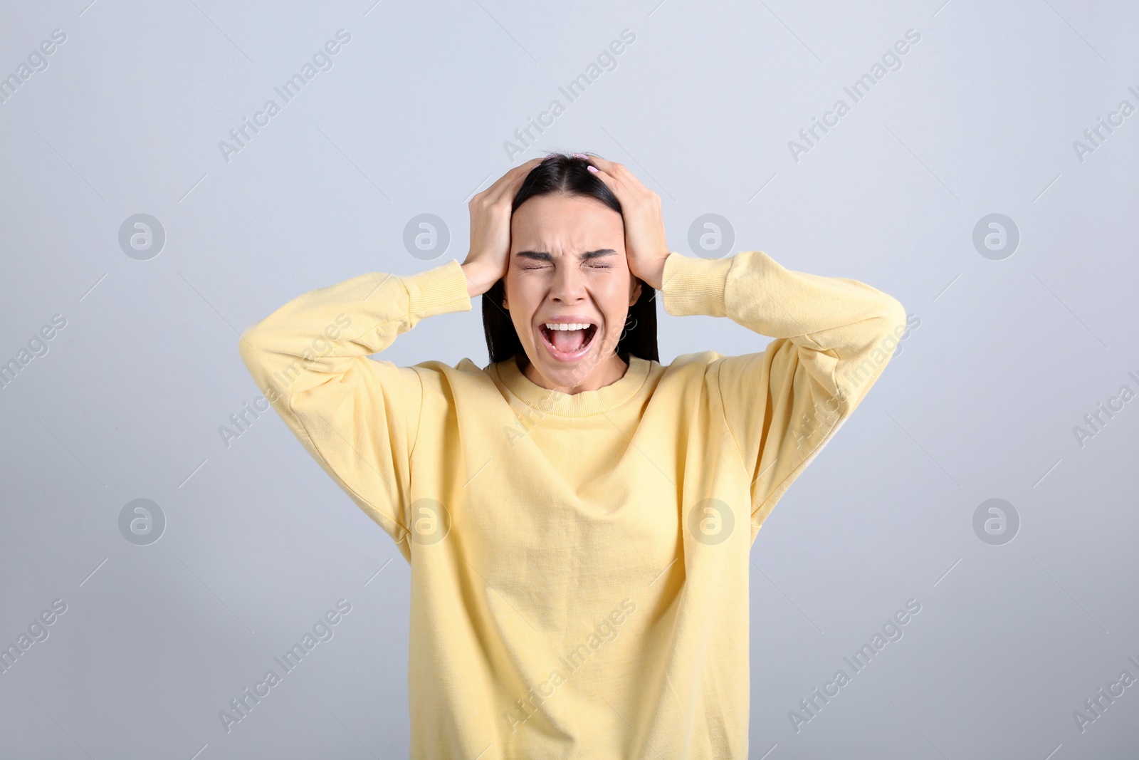 Photo of Portrait of stressed young woman on grey background