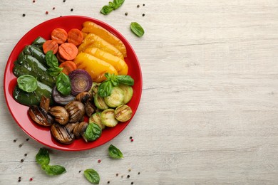 Delicious grilled vegetables on white wooden table, flat lay. Space for text