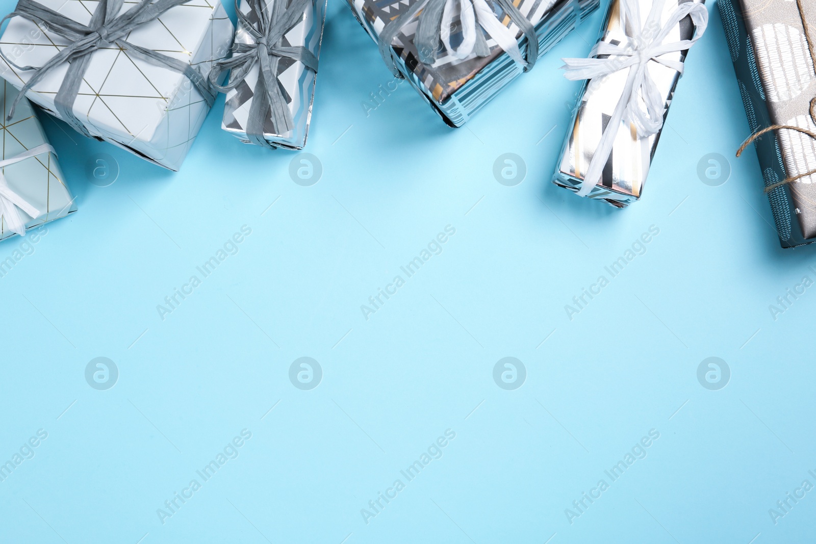 Photo of Flat lay composition with beautiful gift boxes and space for text on color background