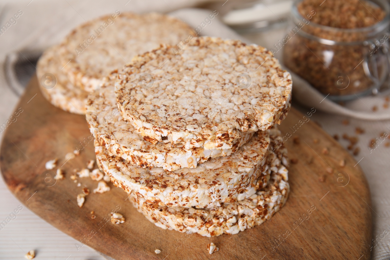 Photo of Stack of fresh crunchy rice cakes on white wooden table, closeup