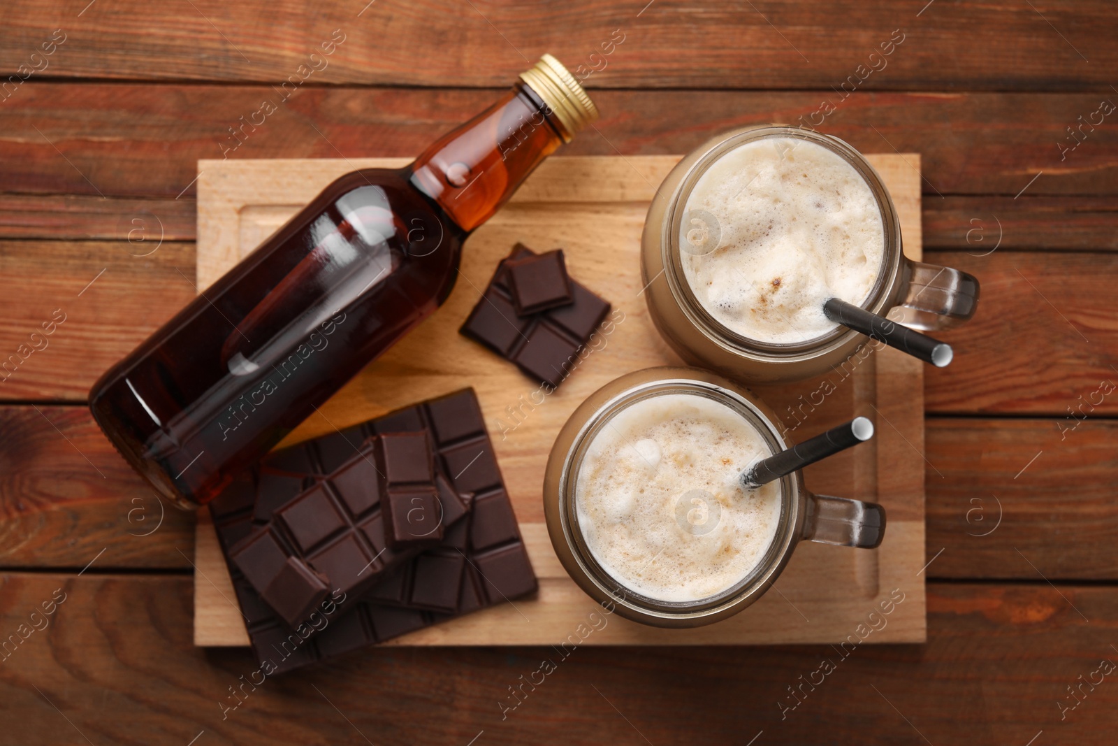 Photo of Delicious coffee with chocolate syrup on wooden table, top view