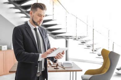 Male lawyer working with tablet in office