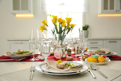 Festive Easter table setting with floral decor in kitchen