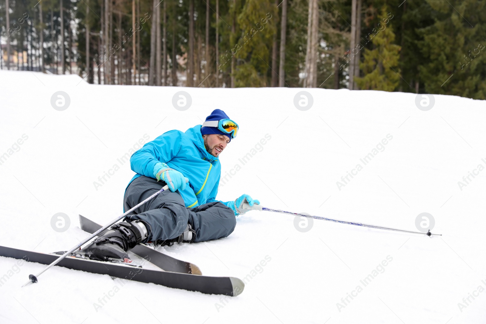 Photo of Clumsy skier on slope at resort. Winter vacation