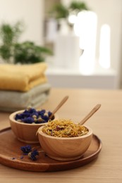 Photo of Dry flowers on wooden table indoors, space for text. Spa time