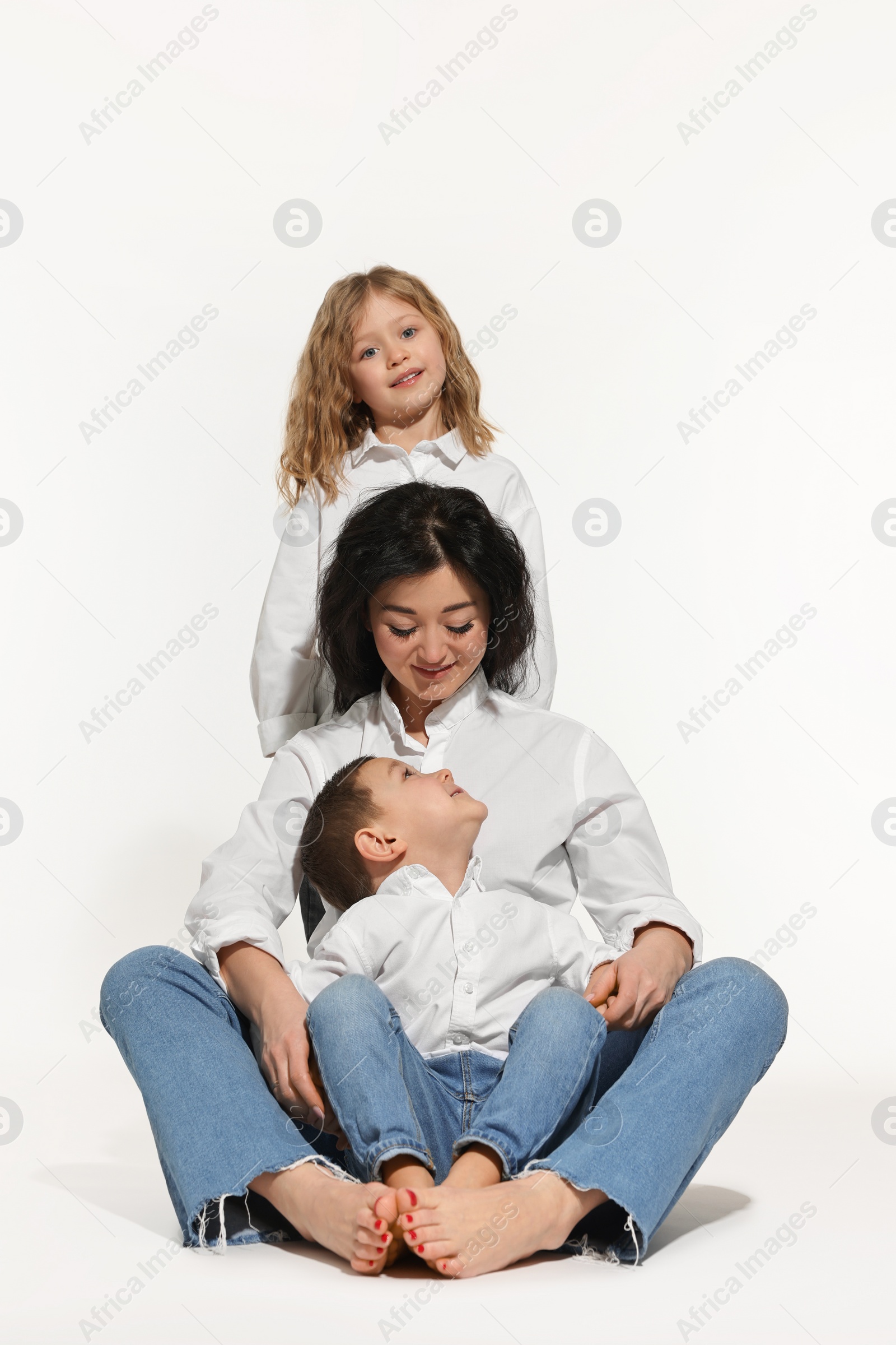 Photo of Little children with their mother on white background