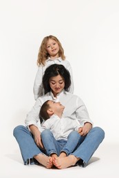 Little children with their mother on white background