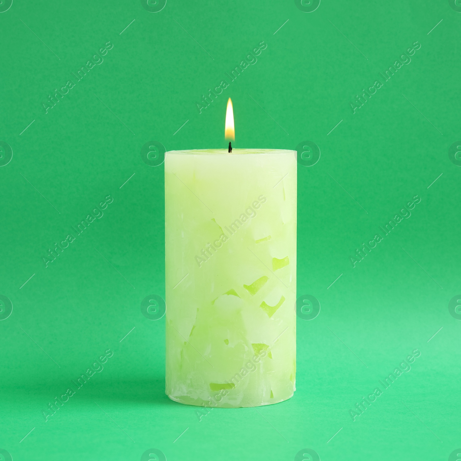 Photo of Alight scented wax candle on color background