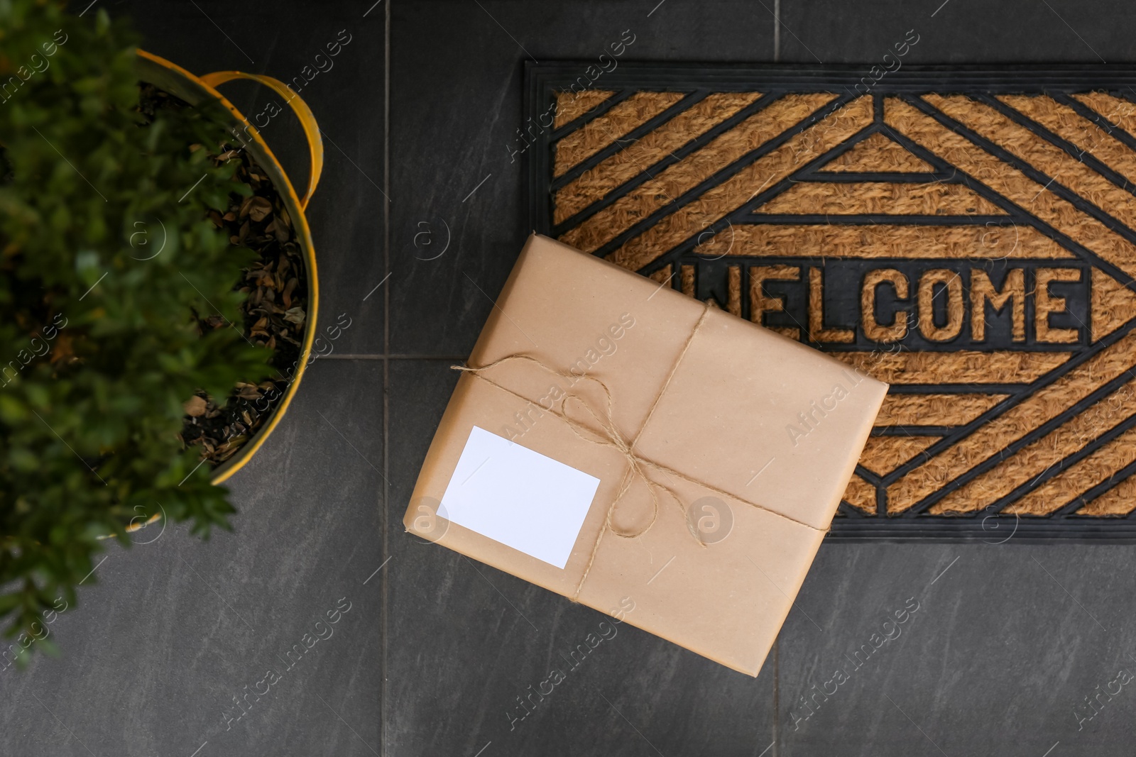 Photo of Delivered parcel on door mat near entrance, top view