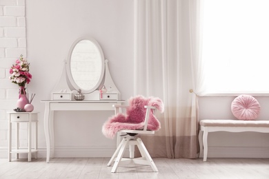 Stylish room interior with white dressing table