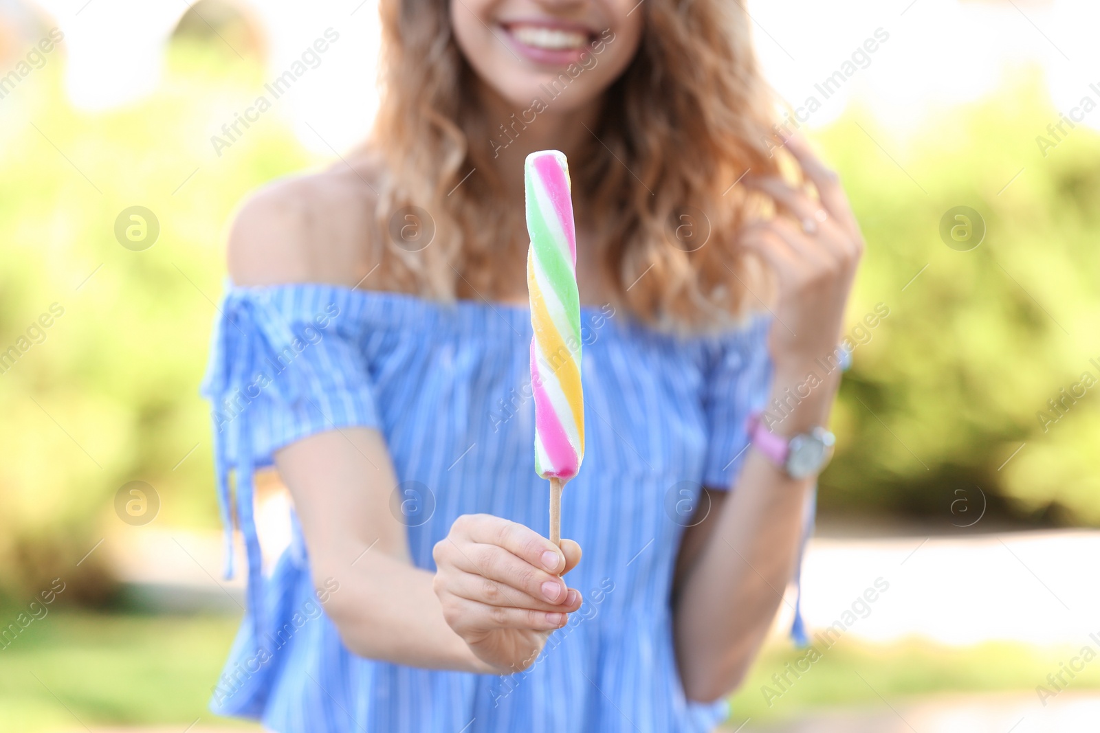 Photo of Happy young woman with delicious ice cream outdoors, closeup