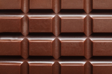 Tasty dark chocolate bar as background, top view