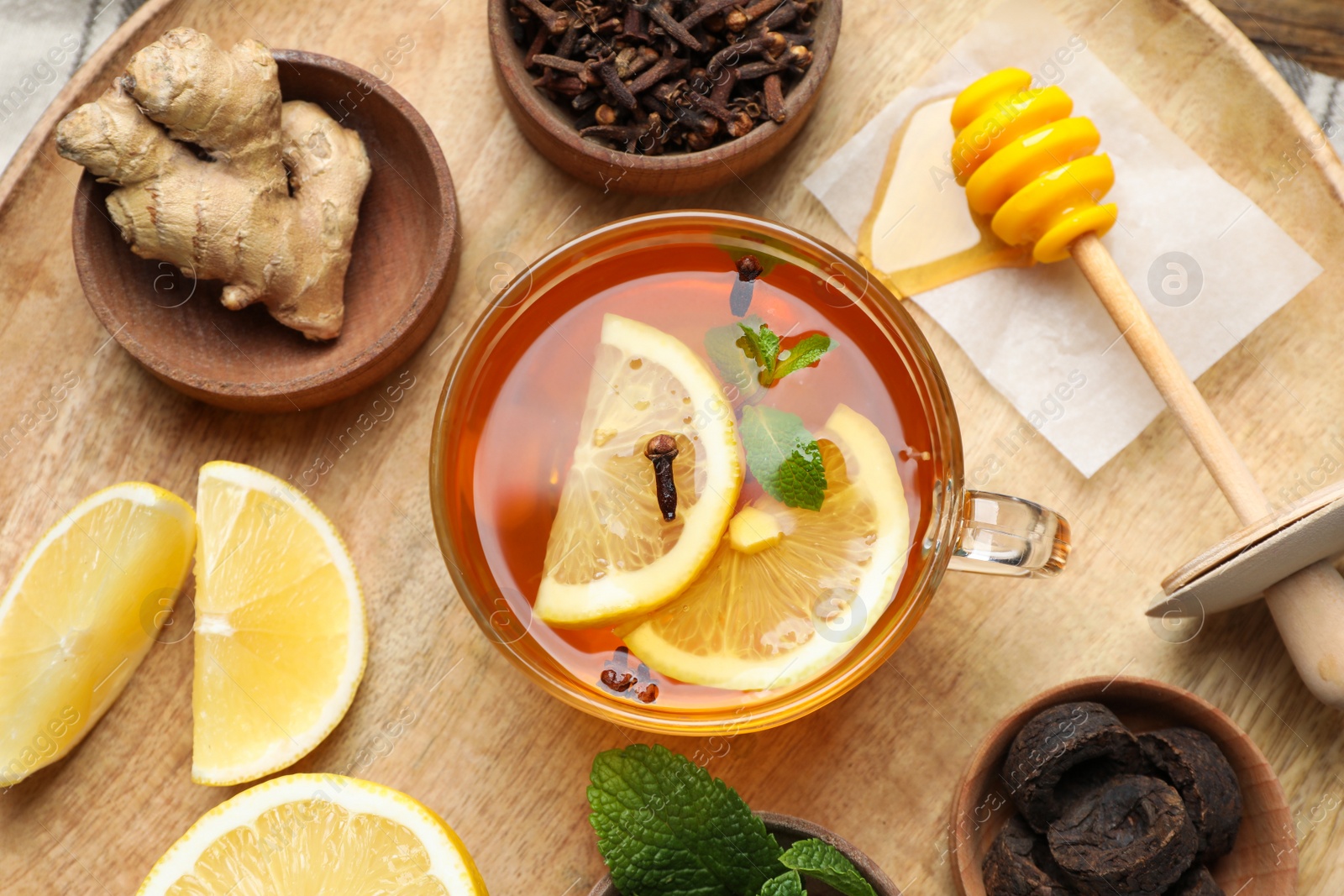 Photo of Tray with immunity boosting drink and ingredients on wooden table, top view