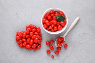 Flat lay composition with fresh goji berries on grey background