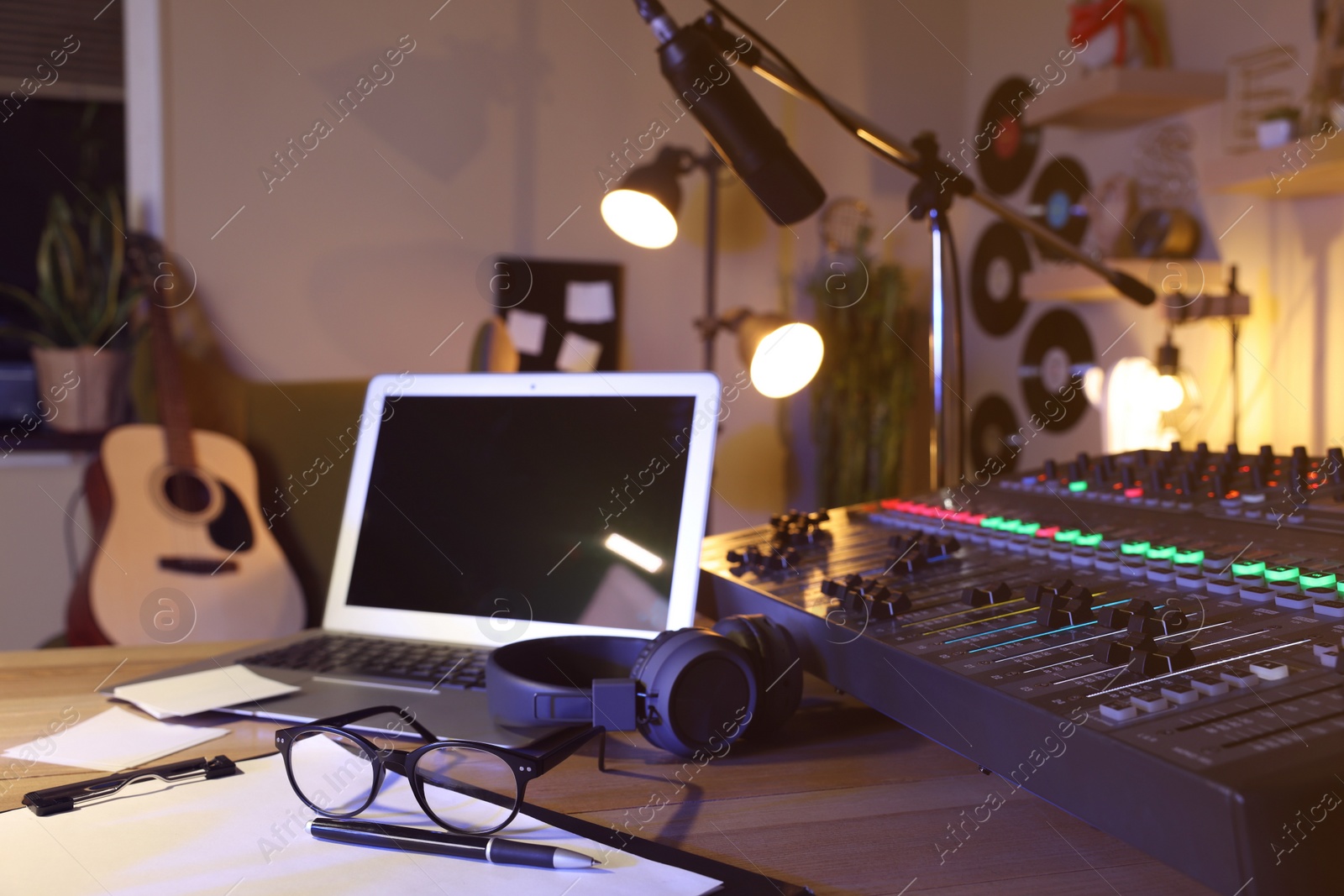 Photo of Professional audio equipment on table in modern radio studio