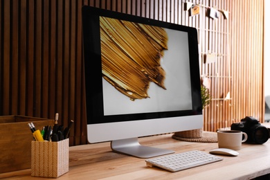 Photo of Modern computer on desk in room. Home workplace